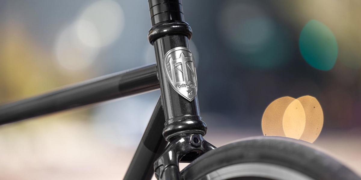 Gray and black All-City Cycles Big Block bike head badge close-up