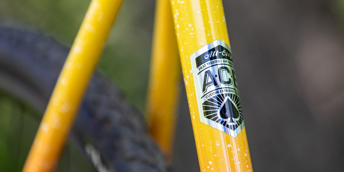 Close-up of A.C.E Tubing decal on seat tube of Nature Cross Single Speed Pink Lemonade bike