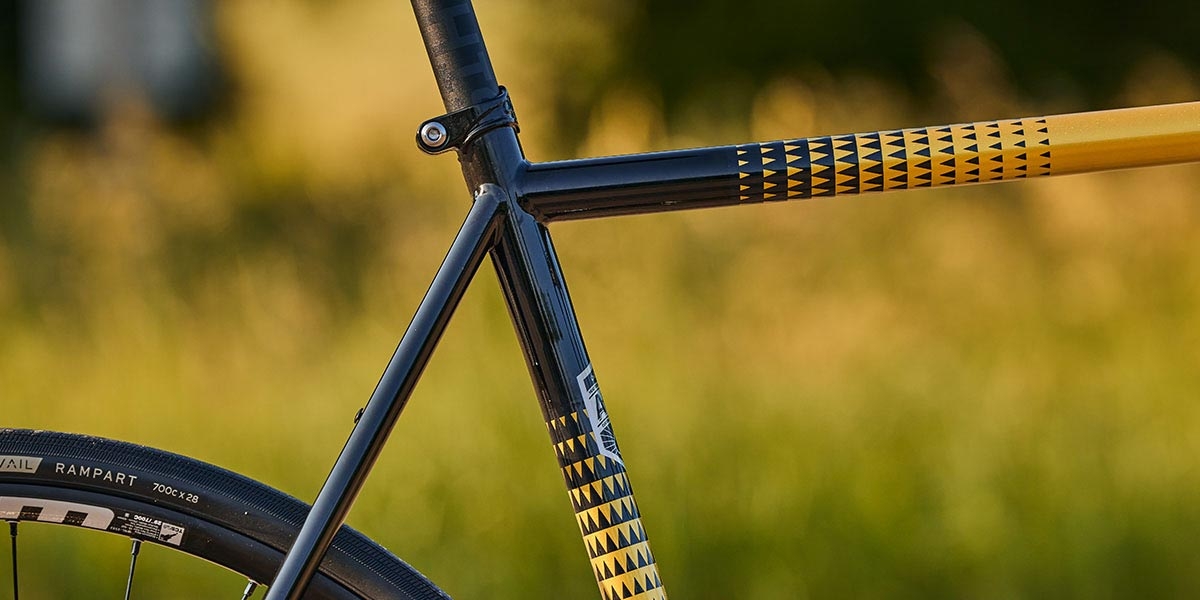 Close-up of Golden Leopard All-City Zig Zag 105 bike showing paint design on top tube, down tube, and seat stays