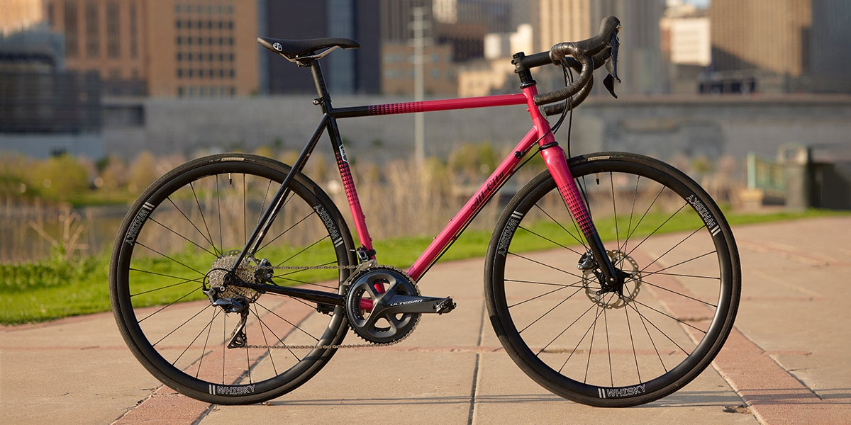 Pink and black All-City Cycles Zig Zag Ultegra complete bike side view in parking lot