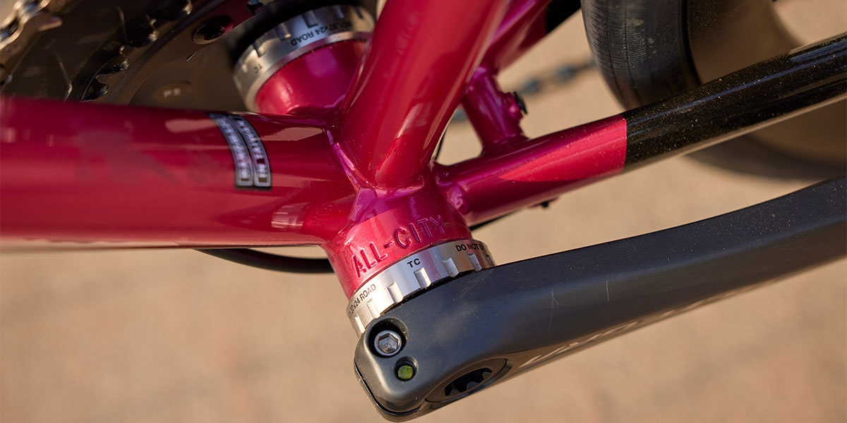Close-up of All-City stamped in bottom bracket shell of pink All-City Zig Zag Ultegra, cranks and BB installed  