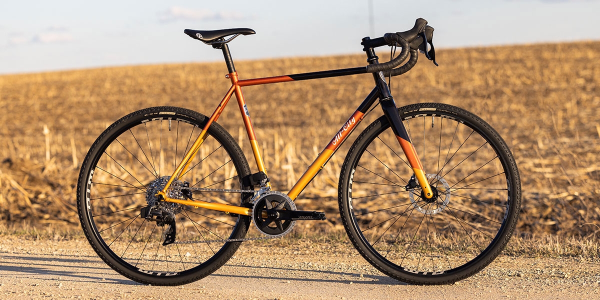 Cosmic Stallion Rival AXS Wide complete bike side view on gravel road