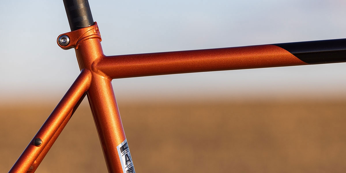 Cosmic Stallion top tube, seat tube detail showing paint in sun, braze on seat post collar, and A.C.E Tubing decal 