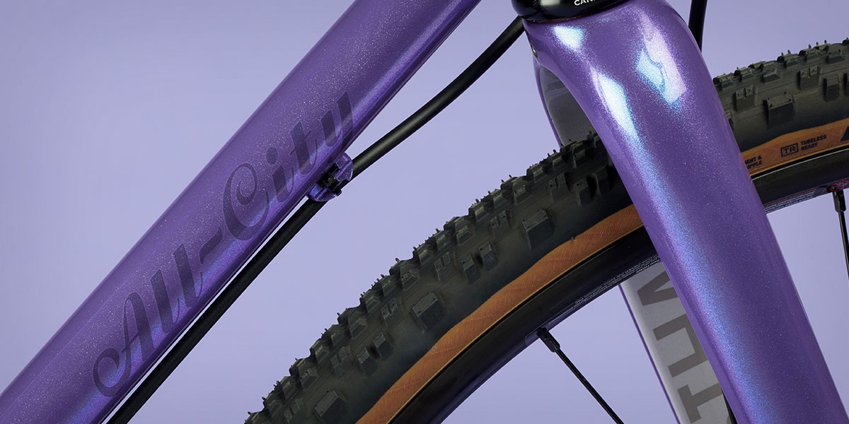 All-City Cycles Super Professional Single Speed Drop Bar bike in Hollywood Violet close up of down tube paint and All-City logo
