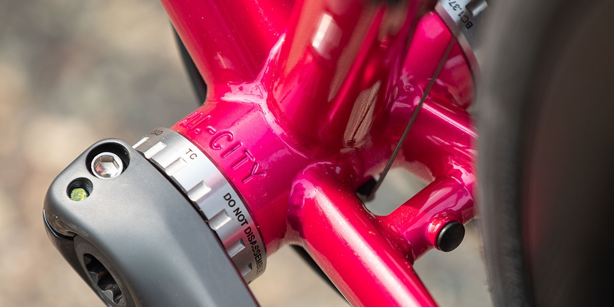 Close-up of All-City stamped in bottom bracket shell of pink All-City Zig Zag Ultegra, cranks and BB installed  