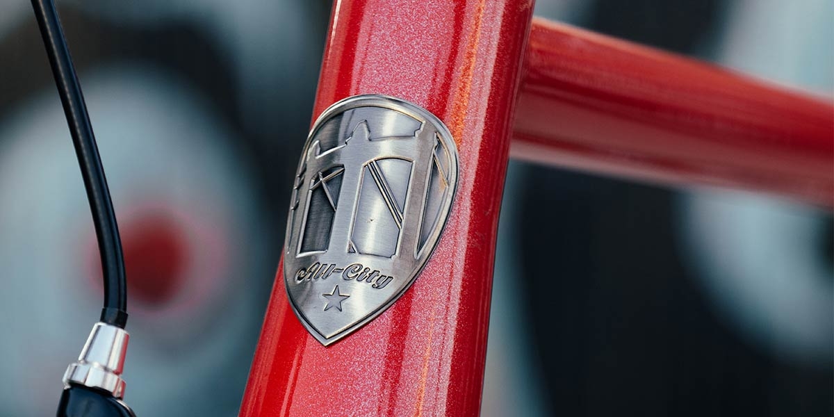 Red All-City Thunderdome bike headtube and headbadge close-up
