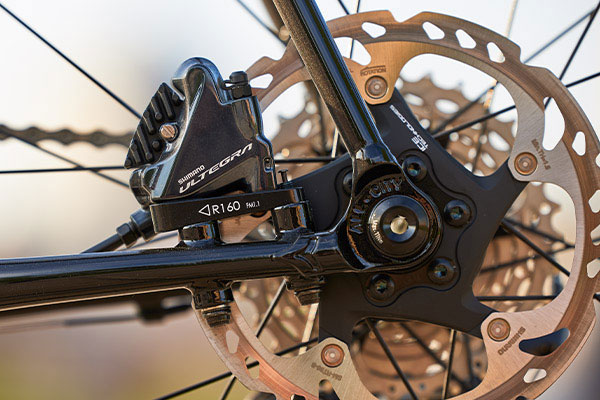 Rear dropout detail on non-drive side of Zig Zag bike showing flat mount Ultegra disc caliper mounted