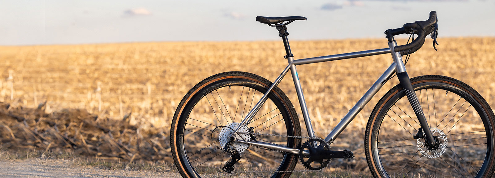 All-City Cosmic Stallion Titanium Frameset built as custom bike on gravel road next to harvested corn field in fall