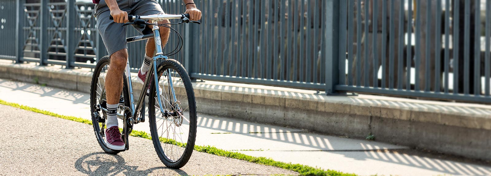 Person riding All-City SpaceHorse bike outside on street, focus on bike