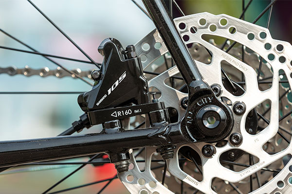 Rear dropout detail on non-drive side of Zig Zag bike showing flat mount Ultegra disc caliper mounted