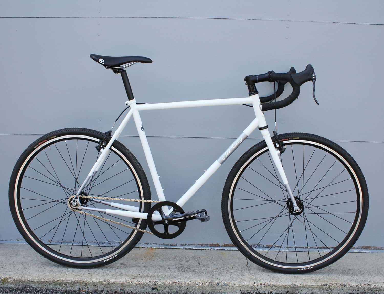 Nature boy white bike against gray wall