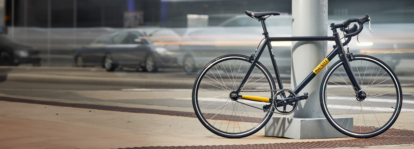 All-City Thunderdome bike leaning against light post on city street