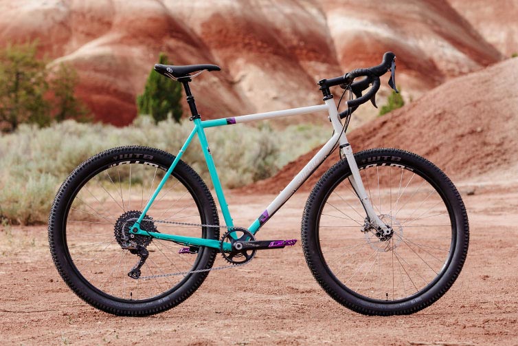 All-City Gorilla Monsoon GRX complete bike in Aqua Seafoam color, side view against outdoor background