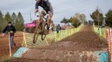 Pat Goretraill jumps bike in black helmet and jersey on a dirt trail