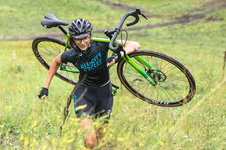 Person carries green and black All-City Macho King outdoor trail