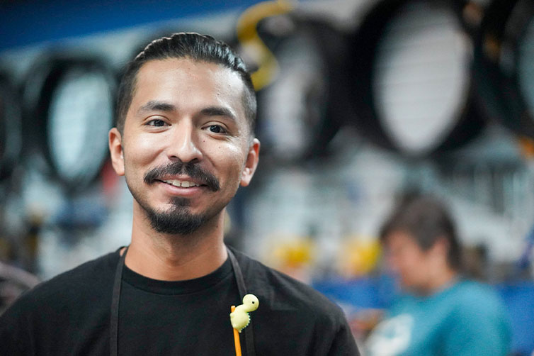 Bike mechanic smiling