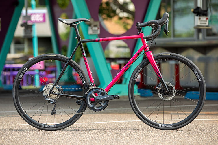 Zig Zag Ultegra in Sour Cherry Seltzer bike side view in parking lot