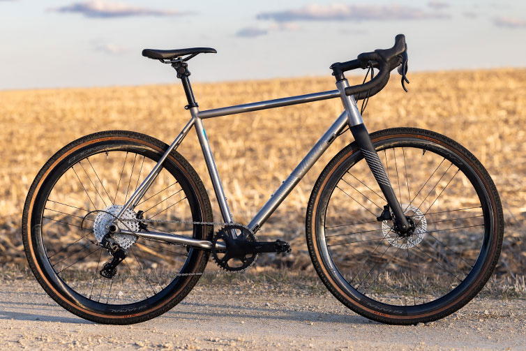 All-City Cosmic Stallion Ti custom built complete bike, side view on gravel road