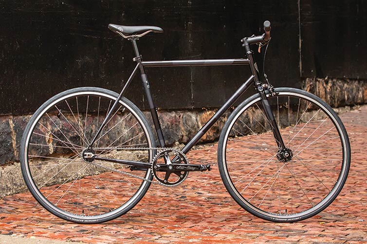All-City Big Block complete bike, Night Sky/Smoke, side-view, propped-up on brick road