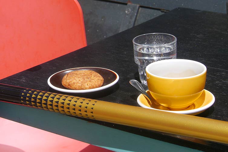 Coffee and pastry on table with Zig Zag bike top tube in picture