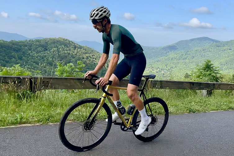 Bennett Shane out of the saddle climbing road on Golden Leopard All-City Zig-Zag