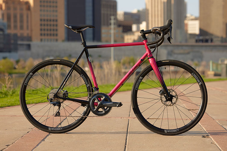 All-City Zig Zag Ultegra Sour Cherry Seltzer bike side view on urban patio