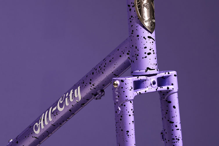 All-CIty Gorilla Monsoon frameset in Lavender Haze color detail view of head tube and fork crown on purple background