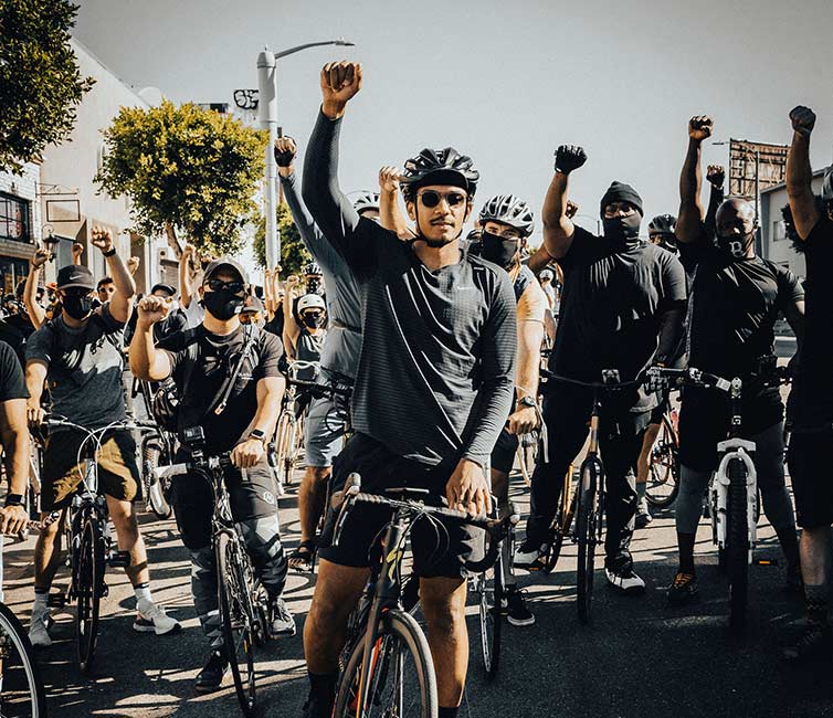 Ron Holden with fist up along with many others at Ride For Black Lives event