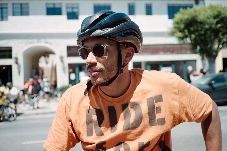 Ron Holden wearing cycling helmet and sunglasss on sunny day during Ride For Black Lives event