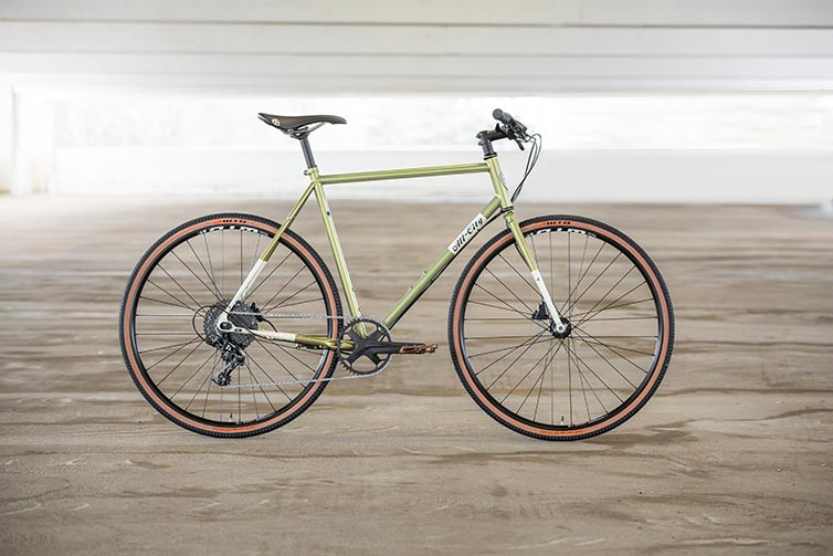 All-City Super Professional Apex 1 bike side view, Flash Basil color, in empty parking garage