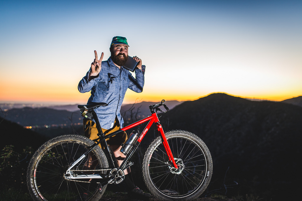 Red All State Bike and rider giving peace sign
