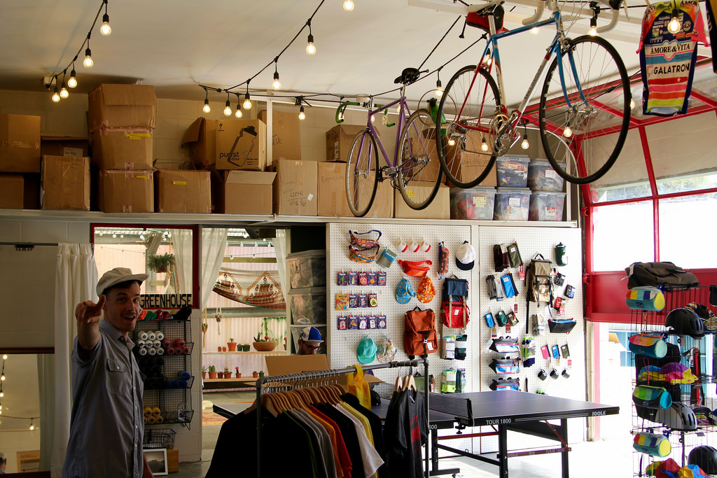 A photo of a bicycle shop with bicycles hanging from the ceiling
