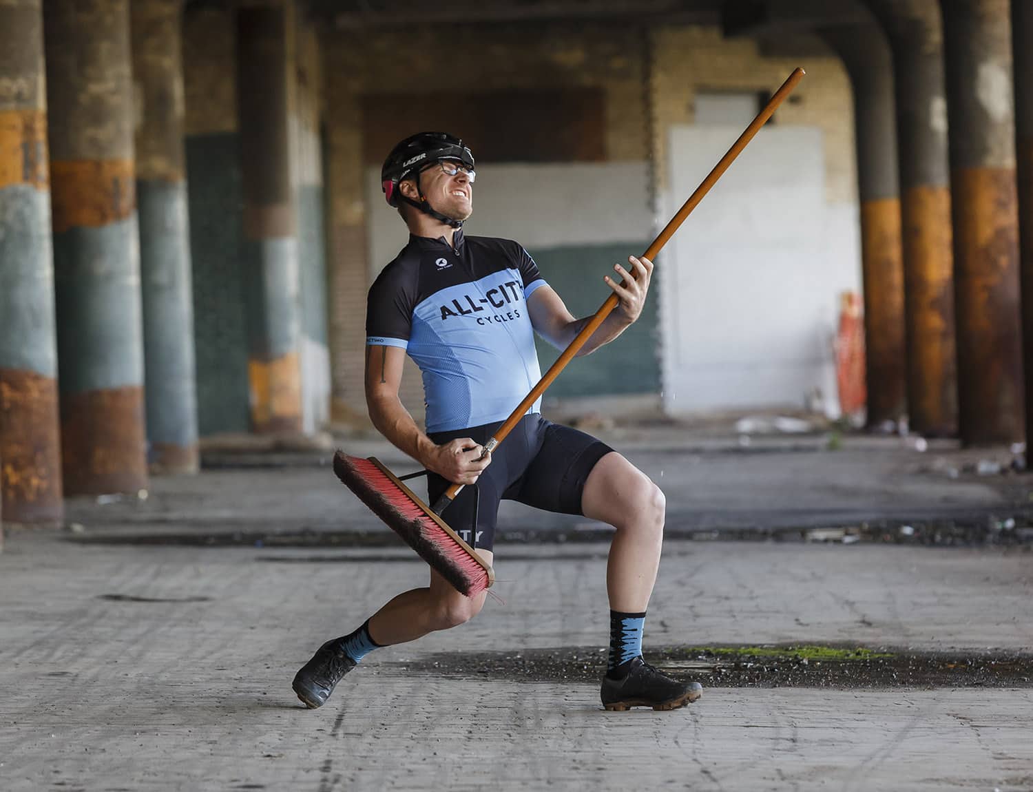 Person wearing blue and black classic All-City Jersey with industrial background