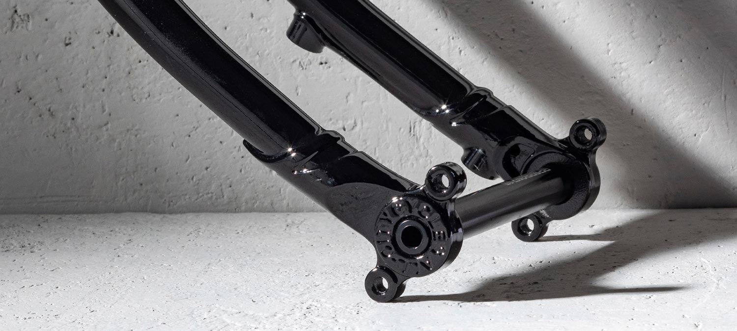 All-City Gorilla Monsoon Fork, black, showing thru-axle dropout on white cement background