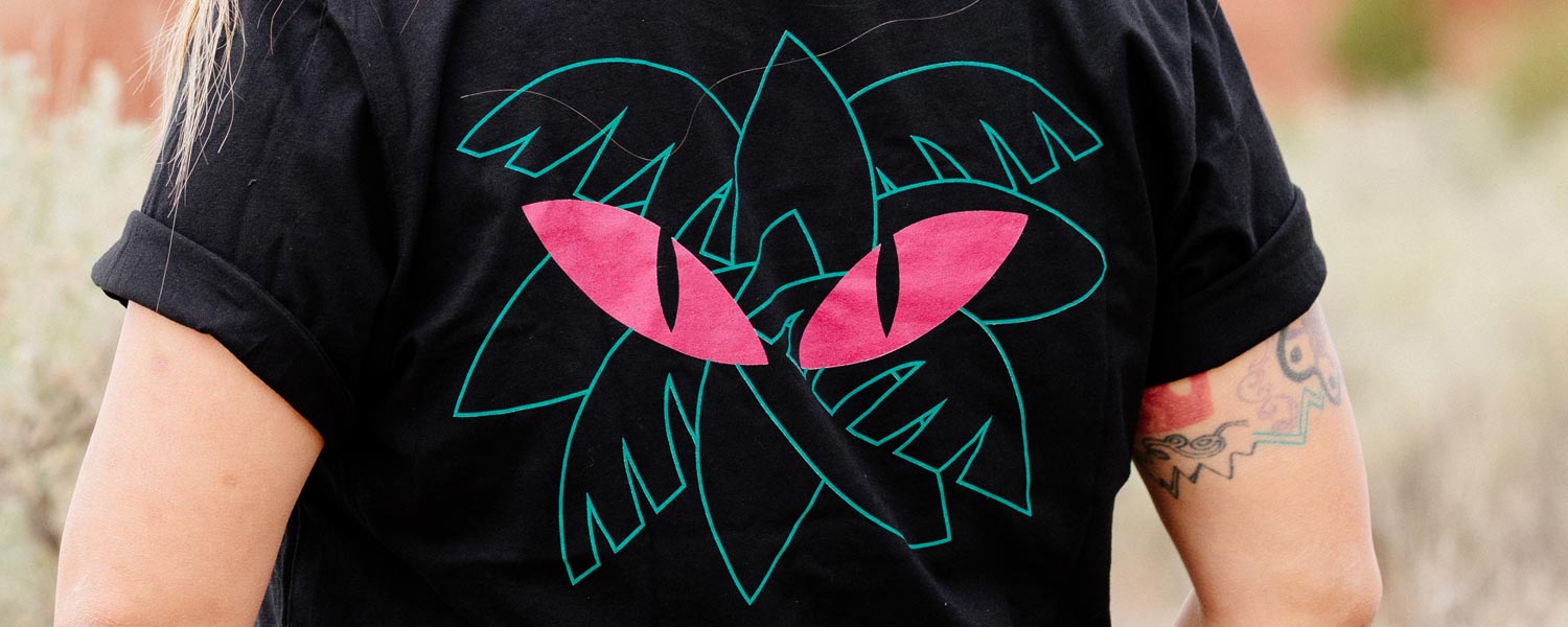 All-City Night Claw T-Shirt worn by person outside showing cat eyes and jungle leaves design on back of shirt