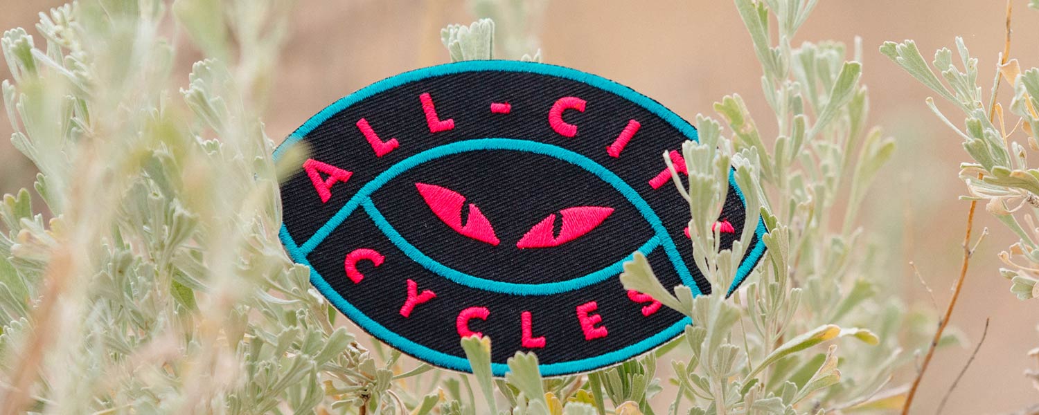 Night Claw Patch close-up showing cat eyes with All-City Cycles text around them