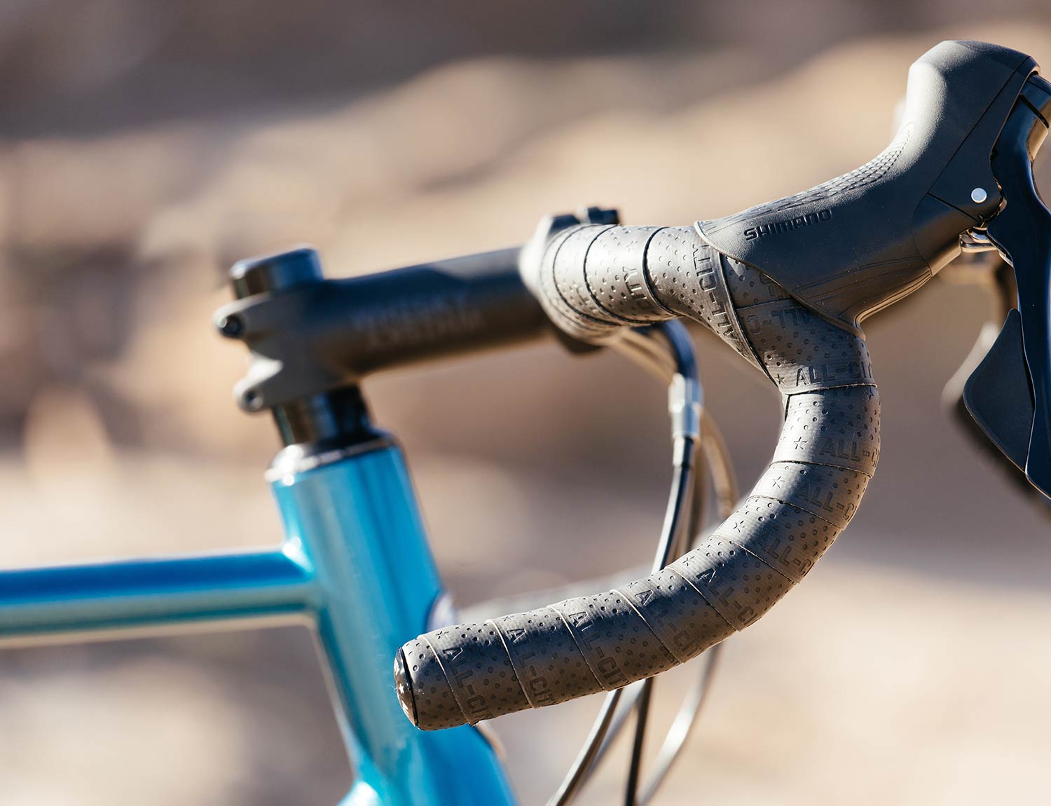 Black All-City silicone Super Cush Bar Tape on blue bike