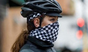 Person in helmet wearing black and white All-City Cycles Tu Tone Neck Gaiter