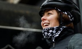 Person in helmet wearing black and white All-City Cycles Tu Tone Neck Gaiter