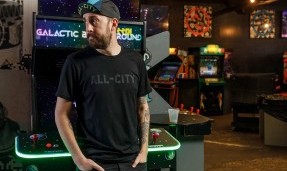Person wears black All-City Cycles Travel Wool Shirt in arcade