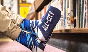 Person wearing All-City Flow Motion blue wool socks with feet close up