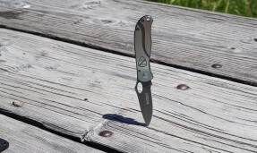 Silver All-City utility knife on wood background