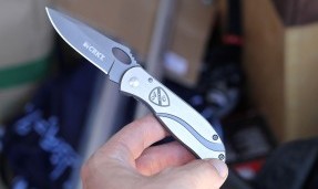 Person holds silver All-City utility knife